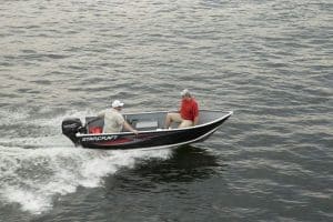 Starcraft Alaskan 13 TL DLX boat cruising on water with two passengers.