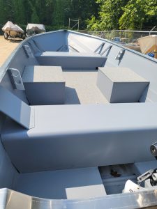 Interior view of the Starcraft Alaskan 13 TL DLX boat showing seating and storage.