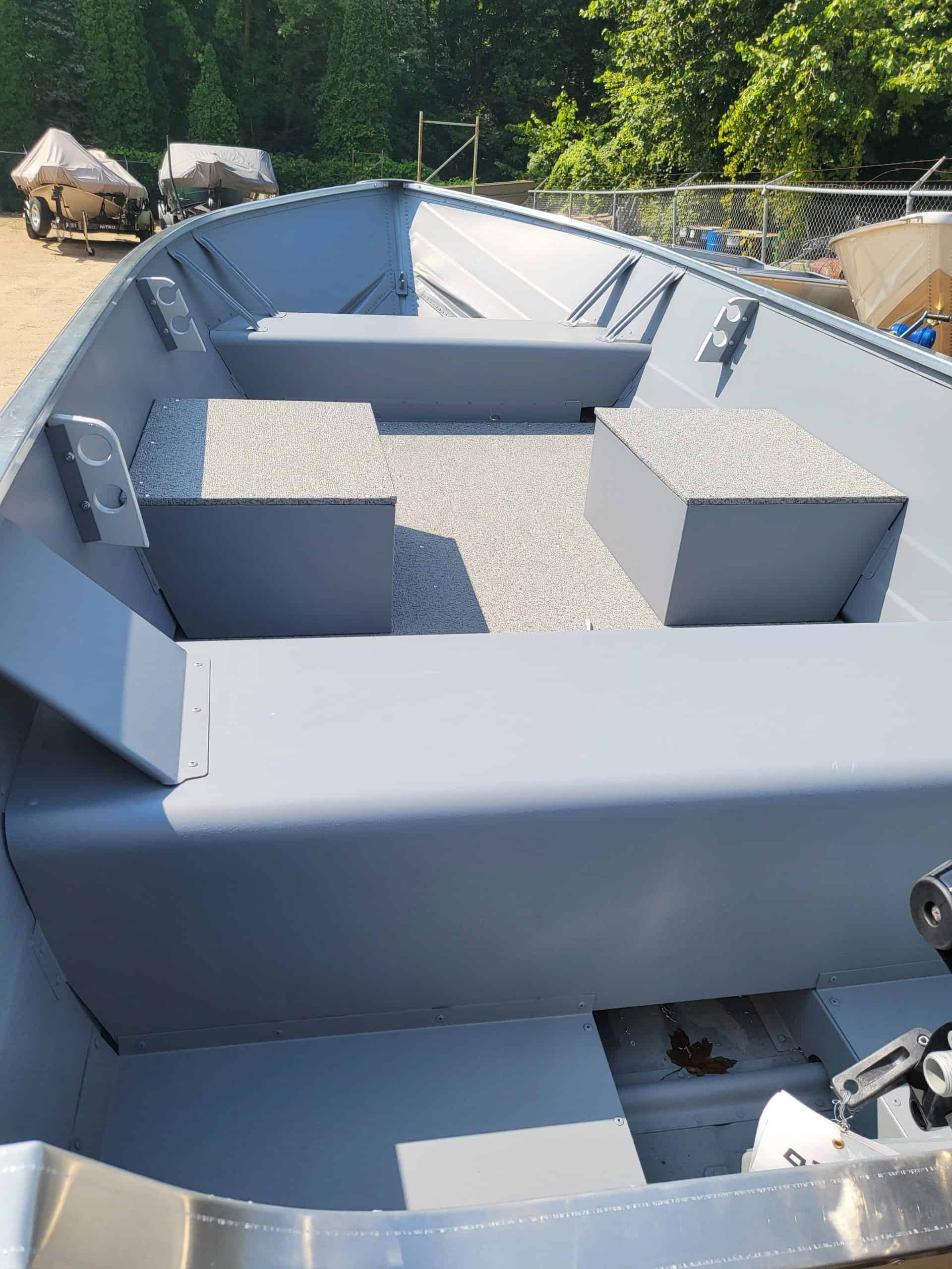 Interior view of the Starcraft Alaskan 13 TL DLX boat showing seating and storage.