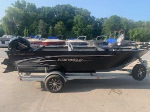 Starweld 19 Flex Tiller boat on trailer with outboard motor and accessories.