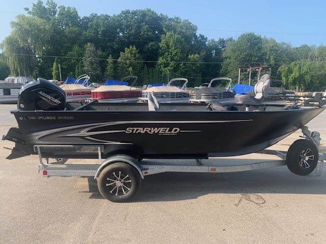 Starweld 19 Flex Tiller boat on trailer with outboard motor and accessories.