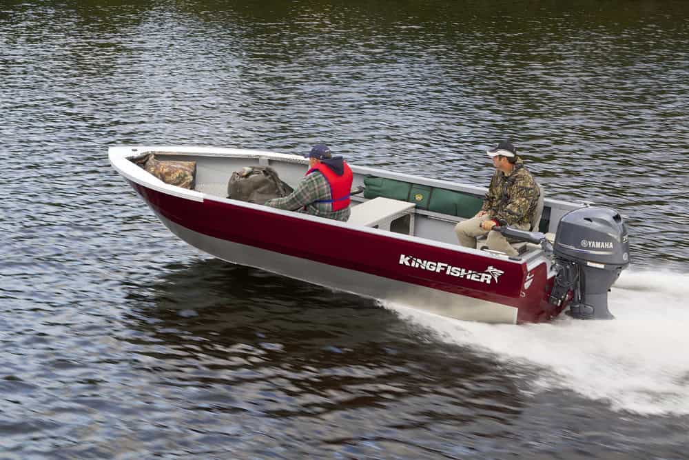 KingFisher 1825 Warrior Tiller boat on water with two people onboard.