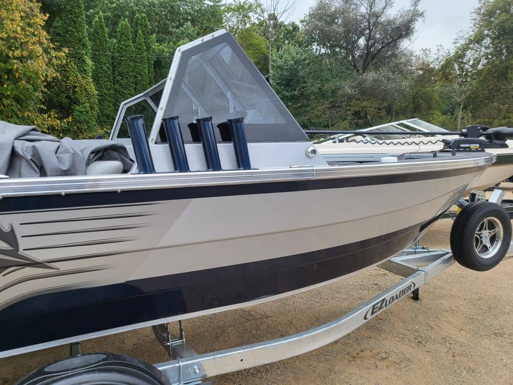 2024 KingFisher Arrow Sport boat on trailer with fishing rods.