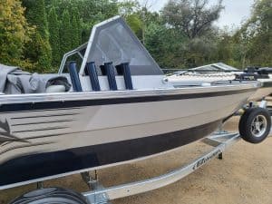 2024 KingFisher Arrow Sport boat on trailer with fishing rods.