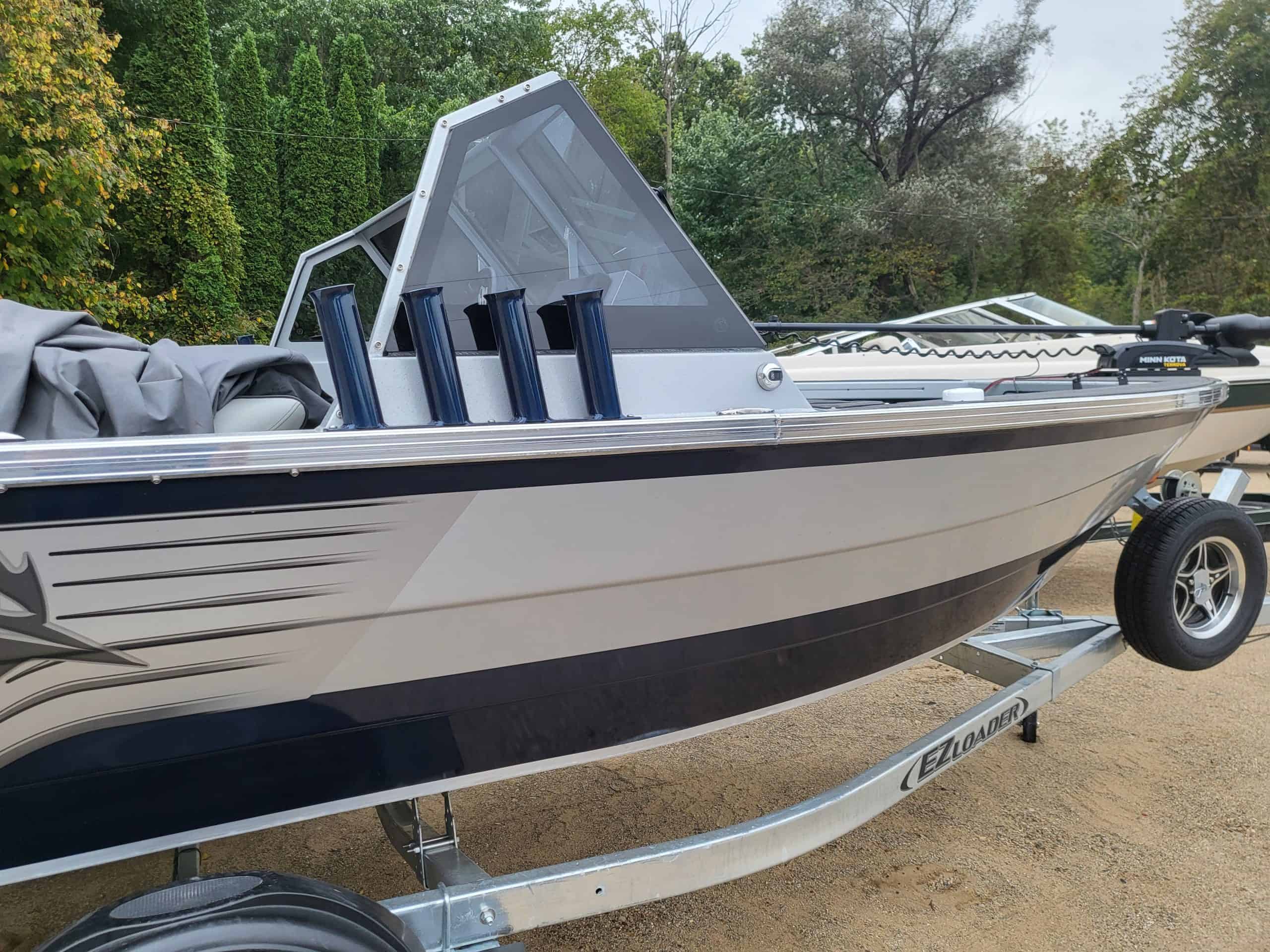 2024 KingFisher Arrow Sport boat on trailer with fishing rods.