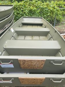 Durable aluminum boat with multiple compartments for fishing or recreation.