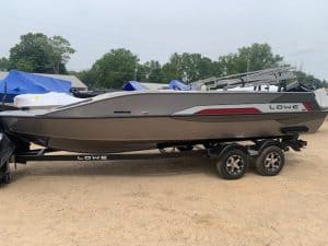 Lowe SD 224 boat on trailer at dealership lot.