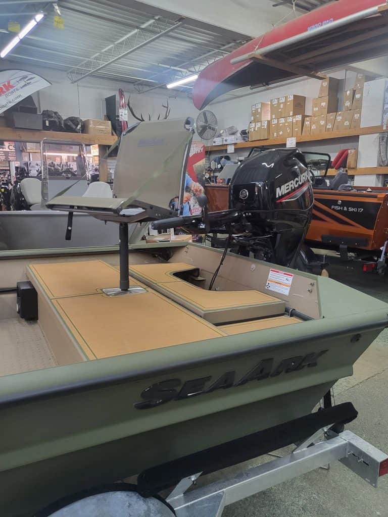 SeaArk 1660 MVT fishing boat with Mercury outboard motor in store.