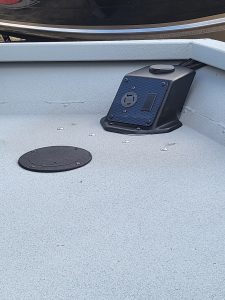 Slip-resistant boat deck with electrical outlet and control panel.