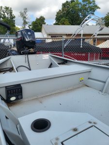 Boat with Mercury engine, geared for fishing, water sports, and lake adventures, available at Camp & Cruise.