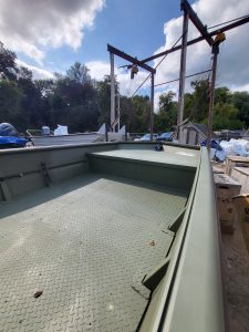 Aluminum boat with durable flooring, perfect for fishing and outdoor adventures, available at Camp & Cruise.
