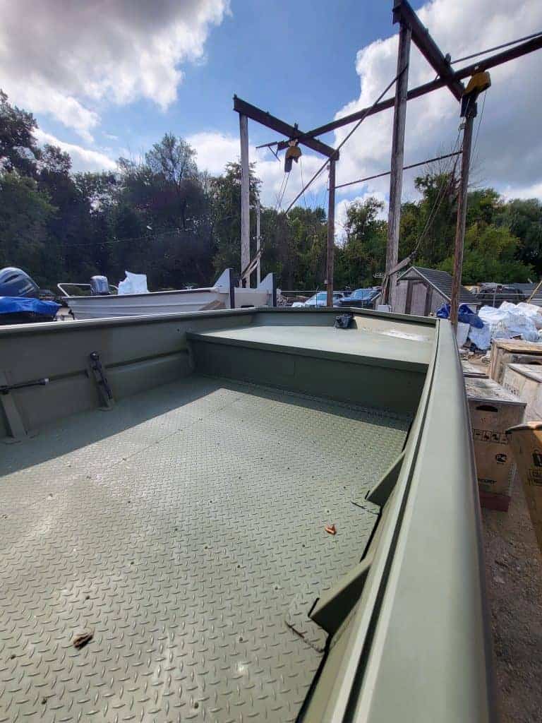 Aluminum boat with durable flooring, perfect for fishing and outdoor adventures, available at Camp & Cruise.