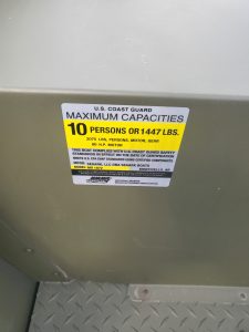 Maximum capacity label for U.S. Coast Guard safety standards.