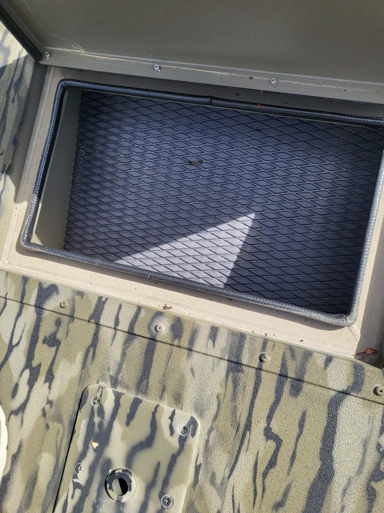 Storage compartment on SeaArk Shadow 18J CC boat for fishing gear.