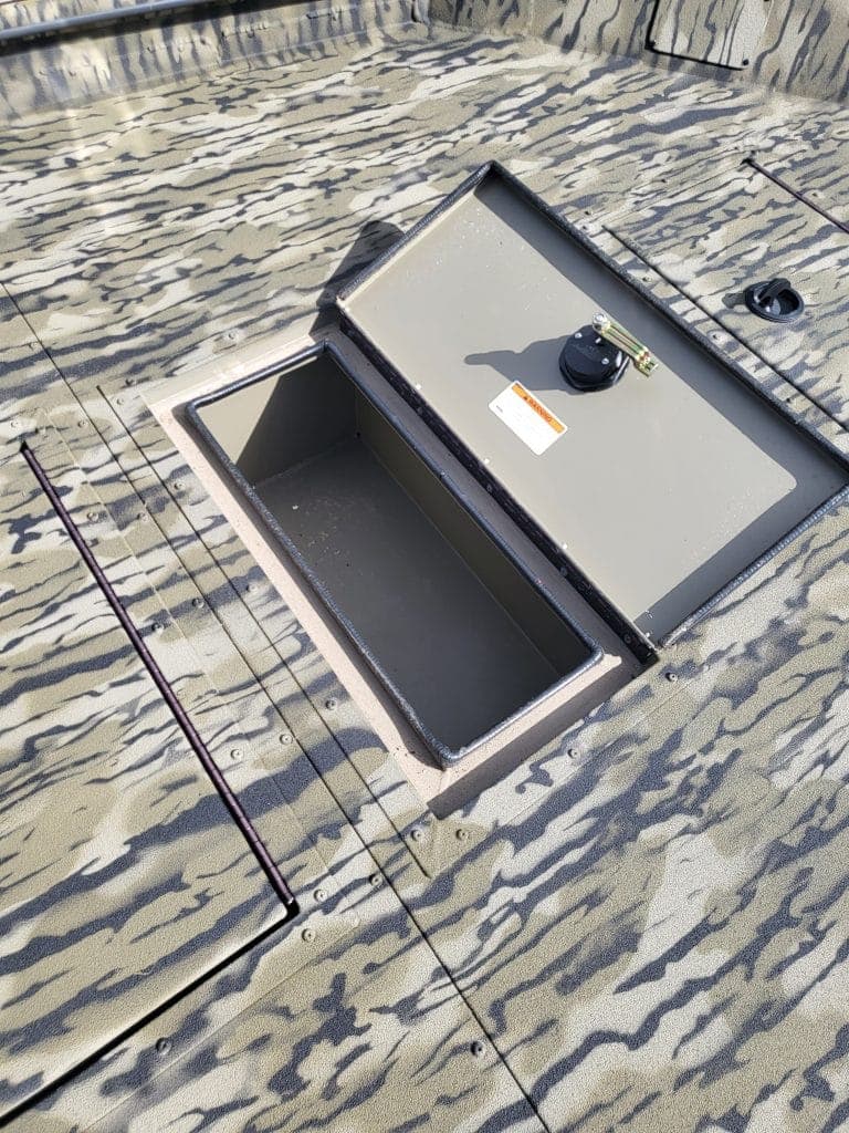 Marine hatch with lock on boat deck for secure storage.