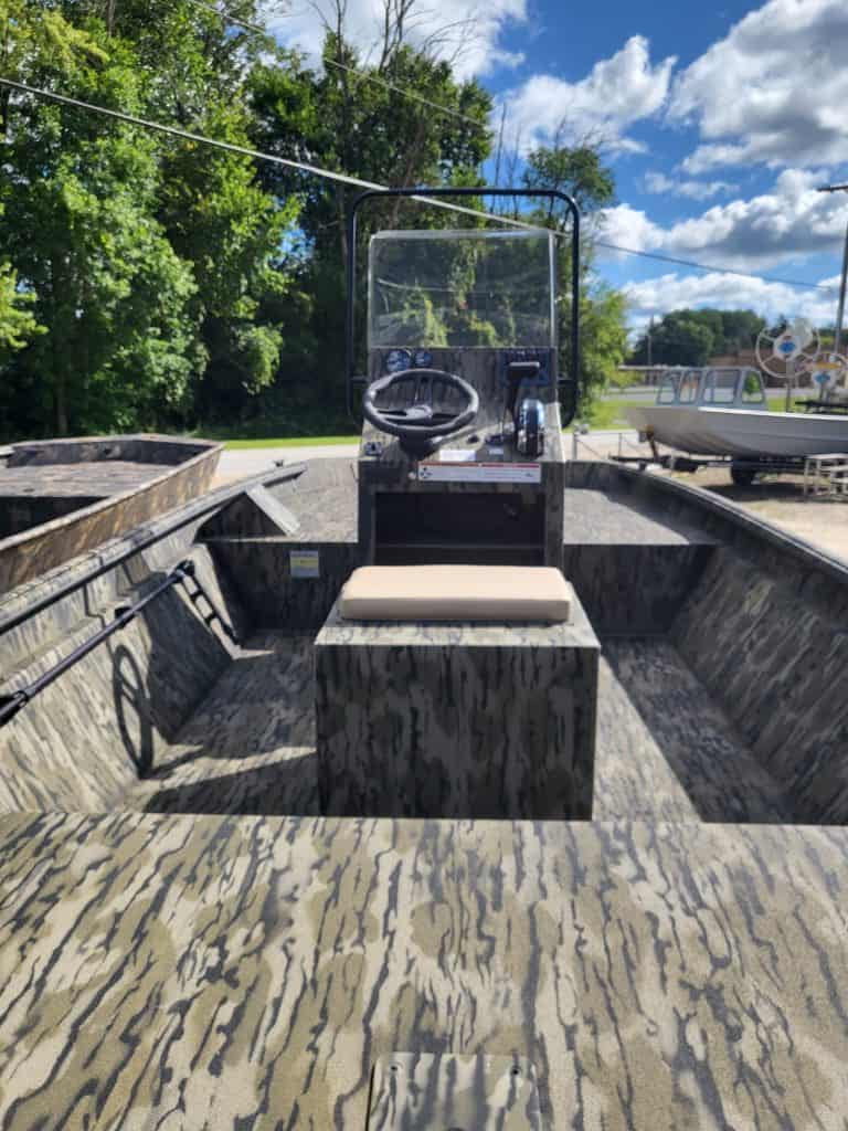 View of boat interior with steering wheel and windshield at Camp and Cruise.
