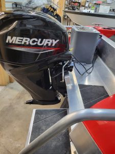 Mercury outboard engine mounted on a boat in a showroom or store.