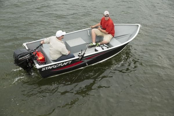 Starcraft Alaskan 13 boat with two men on board in water.