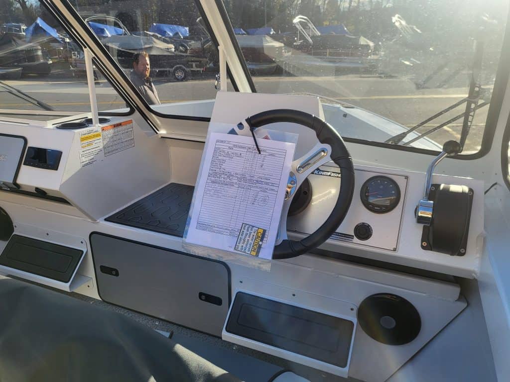 Boat helm dashboard with steering wheel and controls for KingFisher 1975.