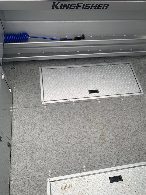 Storage compartment and flooring of KingFisher 2225 Escape HT boat.