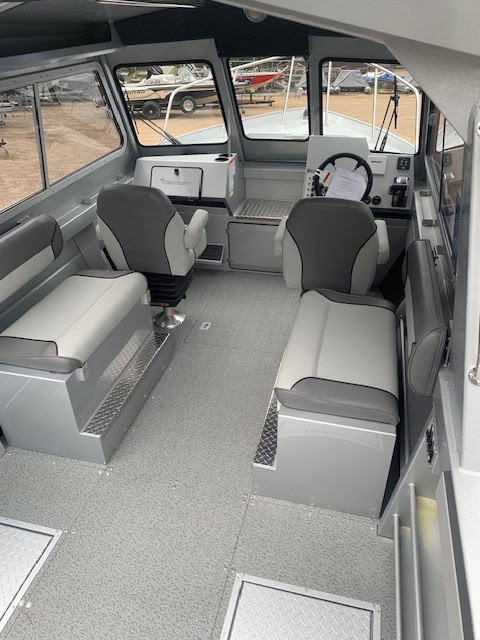 Interior view of the KingFisher 2225 Escape HT boat with seating and controls.