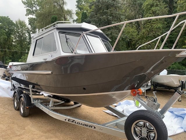 KingFisher 2225 Escape HT fishing boat on trailer at marina.