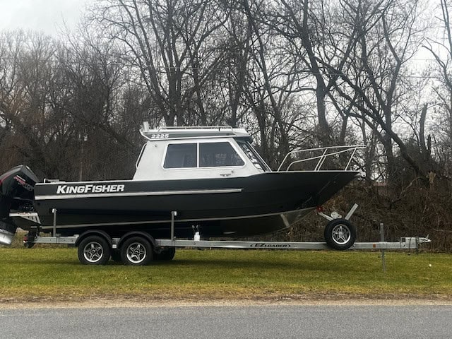 KingFisher 2225 Escape HT boat on trailer in outdoor setting.