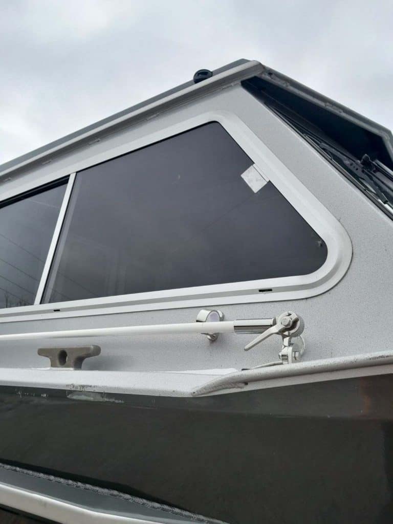 Close-up of the boat's window and hull details on the KingFisher 2225 Escape HT.