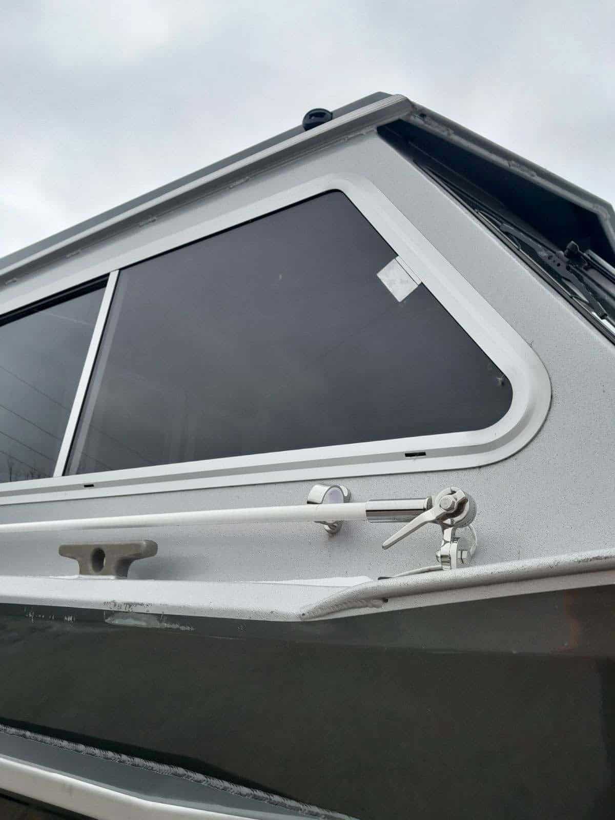 Close-up of the boat's window and hull details on the KingFisher 2225 Escape HT.