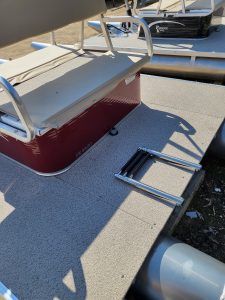 Paddle King PK 4400 pontoon boat on a dock with a step ladder.