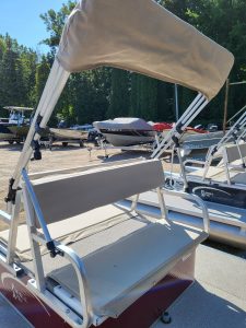 Golf cart bench with canopy and backrest at marina.