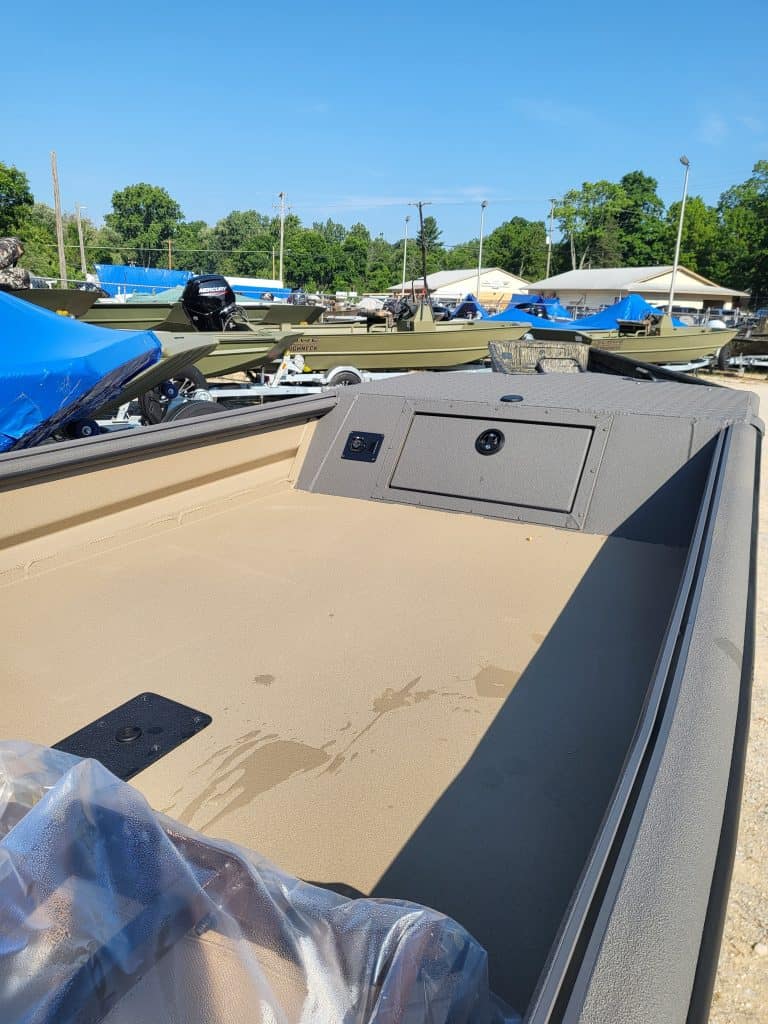 Boat interior with storage and seating for SeaArk 1548-DXS DKLD model.