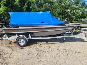 New SeaArk 1548-DXS DKLD boat with blue cover on trailer.
