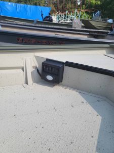 Close-up of boat transom with electronics and registration number.