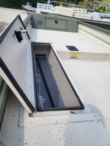 Boat transom storage compartment with lock and electrical outlet.