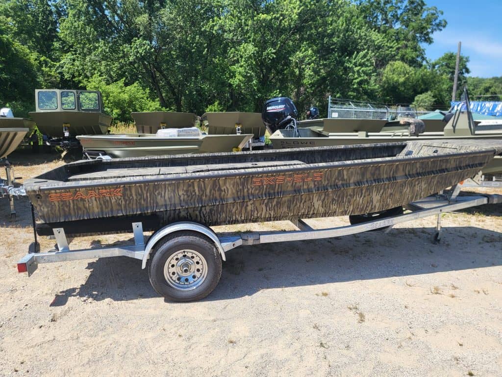 Used aluminum boat on trailer at Camp and Cruise.