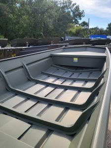 Aluminum boat with protective railing, ideal for fishing and water sports. Ready for outdoor adventures.