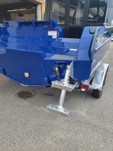 Blue StabiCraft 2250 UltraCab boat on trailer with walk-through design.