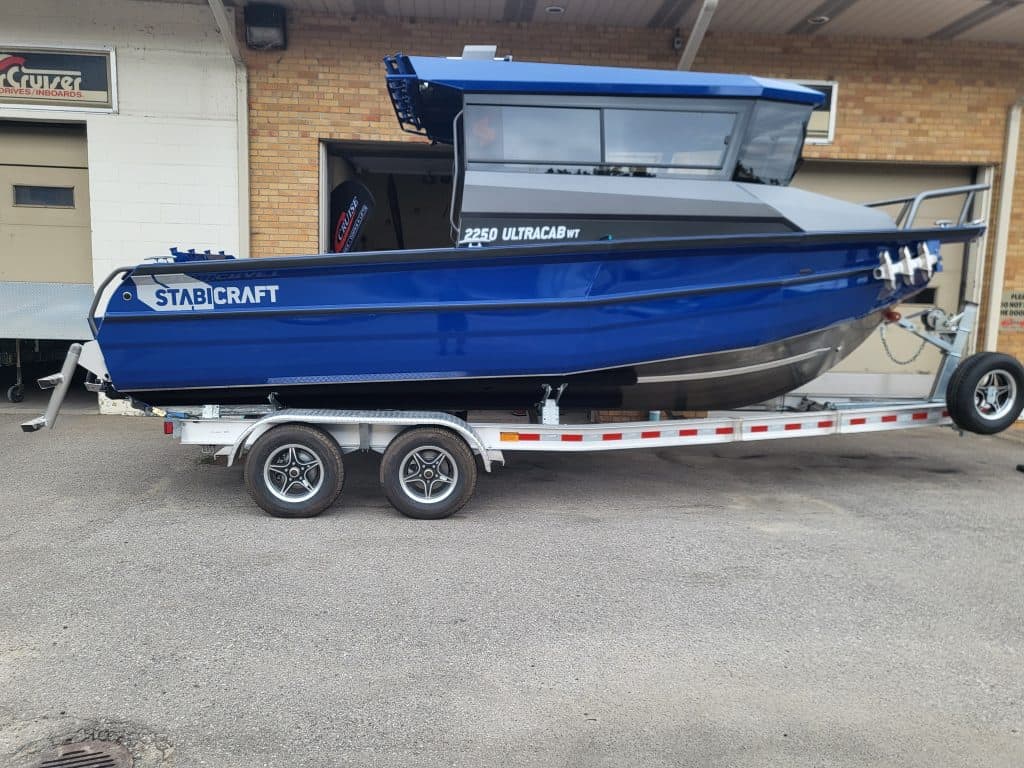 Blue StabiCraft 2250 UltraCab boat on trailer for sale.