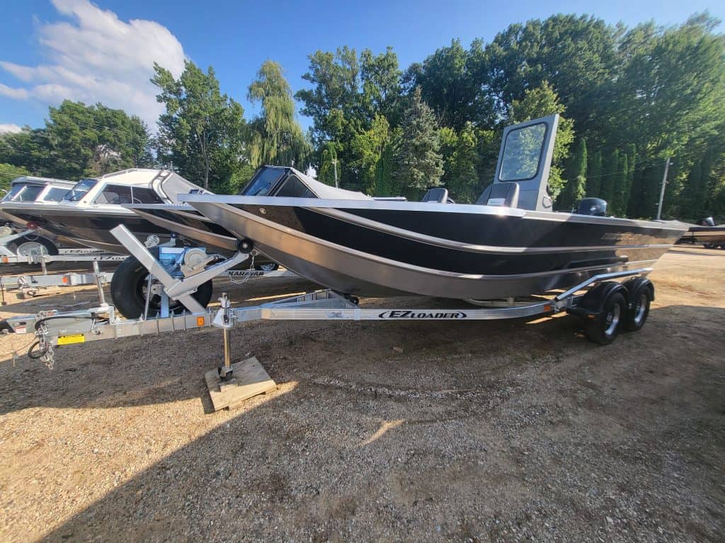 Black and white boat on trailer at Camp and Cruise.