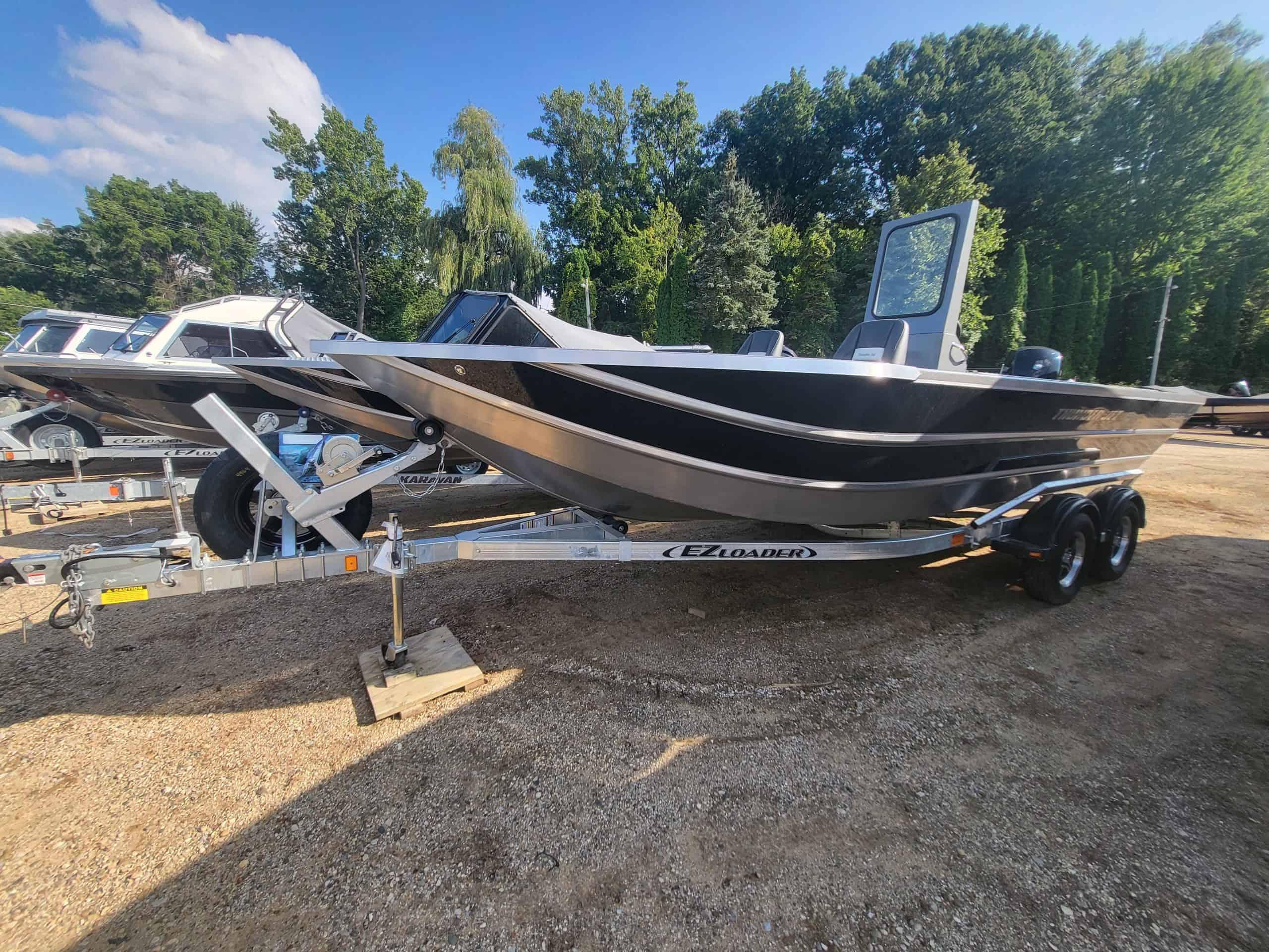 Black and white boat on trailer at Camp and Cruise.