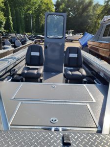 Boat interior with two seats and a central partition at Camp and Cruise.