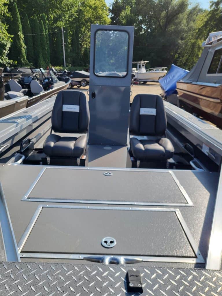 Boat interior with two seats and a central partition at Camp and Cruise.