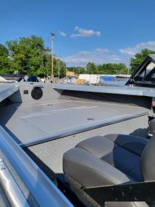 Boat deck with storage hatch and seating at Camp and Cruise.