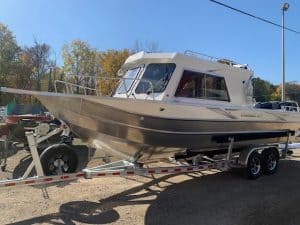 Powerboat on trailer at Camp and Cruise with clear sky.