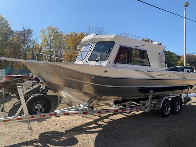 Powerboat on trailer at Camp and Cruise with clear sky.