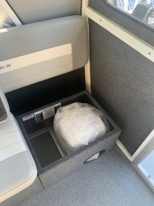 Storage compartment with a wrapped item inside on a boat.