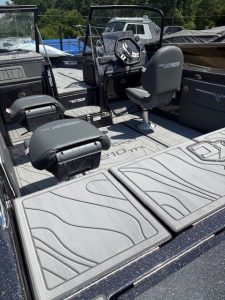 Boat deck featuring seating and steering for outdoor water adventures.