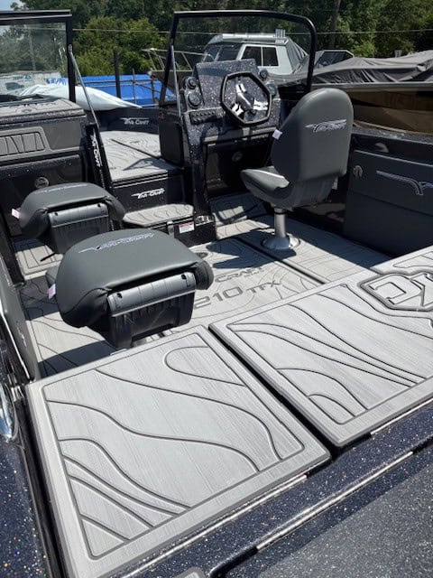 Boat deck featuring seating and steering for outdoor water adventures.