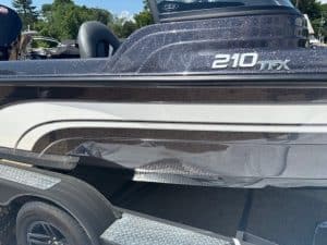 Pontoon boat with sleek black and white design for water recreation.